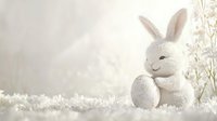White ceramic bunny figurine with Easter egg on snowy winter background with soft bokeh lights and delicate branches, creating magical holiday atmosphere.