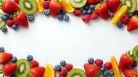 Fresh mixed berries and fruits frame on white background with copy space for healthy eating and nutrition concepts.