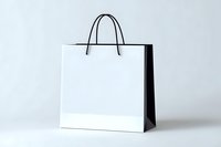 White paper shopping bag with black handles on light background, isolated mockup for retail branding and design presentation.