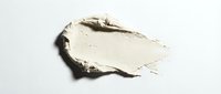 Creamy beige foundation or concealer smear isolated on white background for cosmetic and beauty product advertising campaigns.