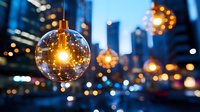 Glowing glass pendant lamps against blurred urban cityscape with bokeh lights create magical evening atmosphere. Modern lighting design in metropolitan setting.