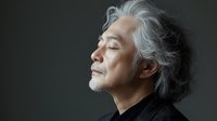 Senior Asian man with gray hair and goatee in black jacket, eyes closed with serene expression against dark background, profile view showing peaceful contemplation.