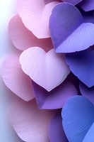 Delicate paper hearts in soft pink and purple hues create romantic composition with gentle shadows and dreamy bokeh effect, suitable for Valentine's Day designs.