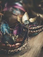 Metallic lotus-shaped decorative bowls with iridescent blue and purple petals on wooden surface, creating mystical eastern atmosphere for spa and meditation spaces.