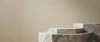 Marble and stone cylindrical pedestals arranged in ascending steps against neutral beige background, suitable for product display and luxury branding.