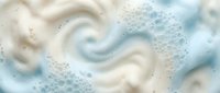 Creamy white and blue swirled foam texture with bubbles, abstract soap lather background for skincare, beauty and cleaning product designs.