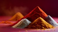 Colorful spice piles arranged as mountains on red surface with dramatic lighting, featuring vibrant curry, paprika, turmeric and other ground seasonings in warm tones.