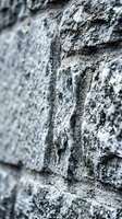 Weathered concrete wall surface with rough texture and natural aging patterns for industrial and urban design projects.