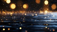 Glowing golden bokeh lights reflecting on dark water surface with rain drops creating magical atmospheric effect. Perfect for seasonal backgrounds.