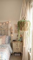 Hanging macramé plant holder with woven jute basket containing trailing succulent plant in cozy bedroom interior with warm lighting and soft neutral decor.