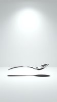Elegant curved spoon and sleek knife isolated on white background, ready for dining, restaurant, kitchenware, and tableware design projects.