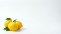 Fresh yellow lemons with green leaves isolated on white background for healthy cooking and citrus fruit designs.