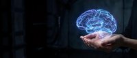 Glowing blue digital brain hologram floating above open palm in dark environment representing artificial intelligence, neuroscience and cognitive technology concepts.