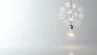 Light bulb with glowing innovation icons representing creative ideas and business solutions on clean white background for presentations.