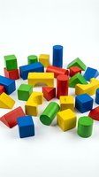 Colorful wooden building blocks scattered on white background featuring cubes, cylinders and geometric shapes for children educational toys and learning.