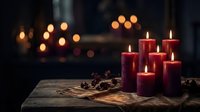 Red pillar candles burning on rustic wooden table with warm bokeh lights creating cozy atmospheric ambiance for relaxation and meditation moments.