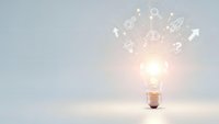 Glowing light bulb with innovation icons and symbols radiating outward on clean white background representing creative ideas and business solutions.