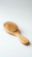 Wooden hairbrush with natural bristles and smooth handle for detangling and styling hair care routines.