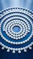 White pills arranged in concentric spiral circles on a blue reflective surface, symbolizing medicine, healthcare, and pharmaceutical concepts.