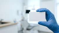 Healthcare professional wearing blue latex glove holding blank white card in clinical laboratory or medical facility setting for identification, credentials, or specimen labeling purposes.