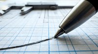 Pen drawing curved line on graph paper with ruler and measuring tools in background, suitable for technical design, engineering, architecture, education, and business planning projects.