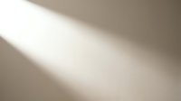 Soft beige gradient background with diagonal light beam creating elegant shadow play for modern minimalist design projects and presentations.