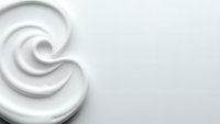 White cream swirl texture with smooth flowing curves on clean background for cosmetic and skincare product design applications.
