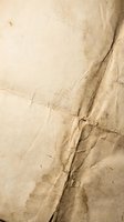 Natural beige sandstone rock formation with weathered cracks and erosion patterns creating organic textures for backgrounds and design projects.