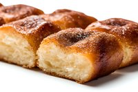 Freshly baked soft dinner rolls with golden brown crust and sprinkled sugar on top, showing fluffy texture inside through cross section on white background.