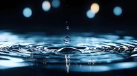 Macro photography of water drop impact creating concentric ripples on liquid surface with blue bokeh lights in dark background. Frozen motion capture.