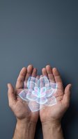 Cupped hands holding glowing holographic lotus flower with digital data streams against dark background for wellness technology and meditation concepts.