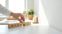 Professional hand arranging wooden blocks with ESG environmental social governance symbols on modern office desk for sustainable business strategy.