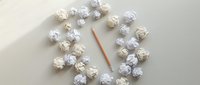 Crumpled paper balls arranged in a circle around a pencil on a light desk, symbolizing brainstorming, creativity, and the writing process.