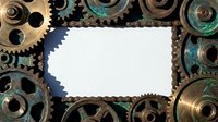 Industrial steampunk frame made of vintage brass gears, chains and mechanical parts with white copy space for text or design elements.