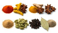 Aromatic spices and herbs collection isolated on white background featuring turmeric, paprika, star anise, ginger, cardamom, peppercorns and bay leaves.