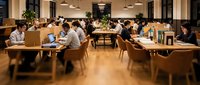 Modern library or study hall with diverse students and professionals working at wooden tables under warm lighting, suitable for education, learning, and collaborative workspace concepts.