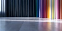 Vibrant multicolored light streaks reflect on glossy floor surface creating dramatic abstract background with rainbow spectrum transitioning from cool blue to warm tones.