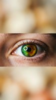 Close-up of striking green and amber heterochromia eye with detailed iris patterns and natural eyelashes on warm blurred background for vision concepts.