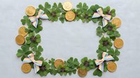 St. Patrick's Day frame with green shamrock clover leaves, gold coins and Irish flag ribbons on white background for holiday greeting cards.