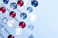 Molecular structure model with red, white and blue spheres connected by silver rods against light background, representing scientific research and chemistry.