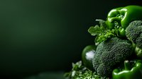 Fresh green vegetables on dark background with dramatic lighting, broccoli and bell peppers close-up with copy space for healthy eating concept.