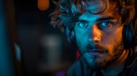 Young bearded man with intense blue eyes in dramatic neon lighting wearing headphones, captured in moody cinematic style with orange and blue color contrast.