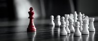 Red king chess piece stands out among white pieces on dark board, symbolizing leadership, strategy, and uniqueness in business competition.