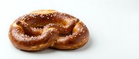 Freshly baked pretzel with golden-brown twisted knot shape and coarse salt crystals, isolated on white background for bakery, food packaging, and menu design use.