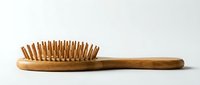 Wooden hairbrush with natural bristles and ergonomic handle for detangling and styling hair care routines.