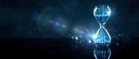 Futuristic digital hourglass with glowing blue light effects against starry space background for time management and technology concepts.