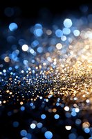 Magical glowing gold and blue bokeh lights on dark background create dreamy abstract pattern with blurred sparkles and defocused circles.