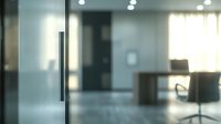 Modern office interior with frosted glass door in foreground, showing blurred desk and chair in background, creating professional corporate atmosphere with natural lighting.