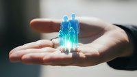 Digital holographic human figures floating above open palm representing healthcare technology, medical innovation, and futuristic patient care solutions.