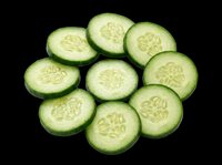 Fresh cucumber slices arranged in a circle, isolated on transparent background, ready for food design, stickers, print on demand, T-shirts, and clipart projects.